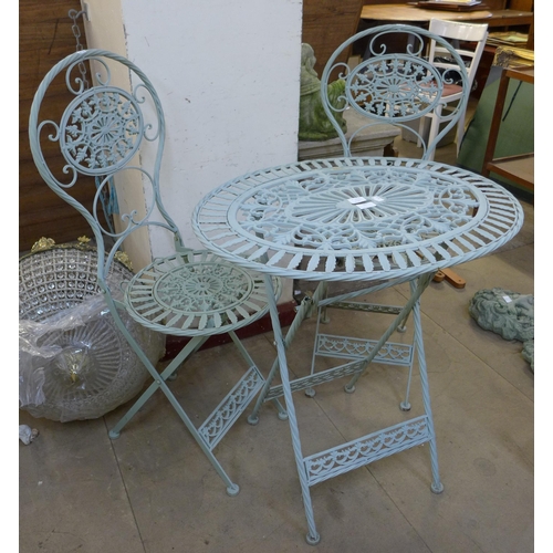 247 - A painted wrought iron folding garden table and two chairs