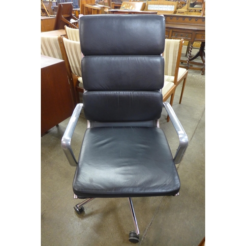 33 - An Eames style chrome and black leather desk chair