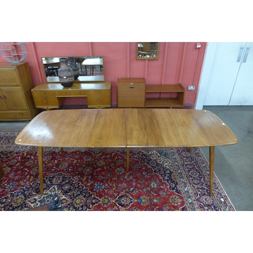 4 - An Ercol Blonde elm and beech extending Grand Windsor dining table