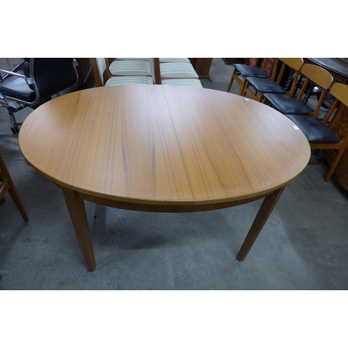 42 - A teak oval extending dining table