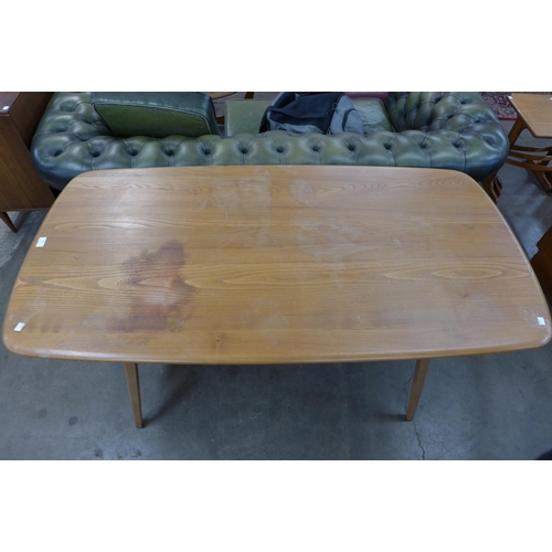 49 - An Ercol Blonde elm and beech plank top Windsor dining table