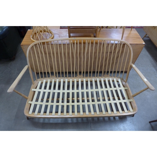 52 - An Ercol Blonde beech Windsor settee, a/f