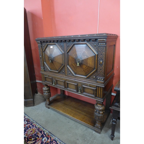 70 - An Elizabethan Revival carved oak geometric moulded cocktail cabinet