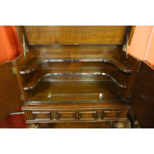 70 - An Elizabethan Revival carved oak geometric moulded cocktail cabinet