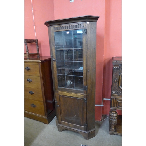 71 - A Nigel Griffiths carved oak freestanding corner cabinet