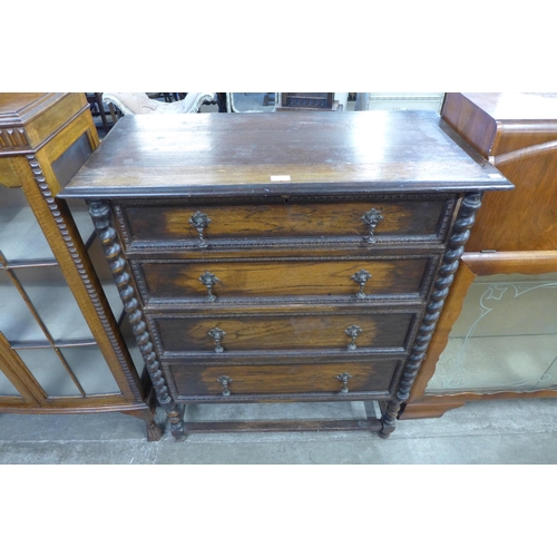 90 - An carved oak barleytwist chest of drawers