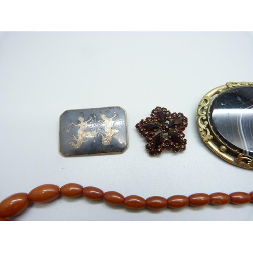 1001 - An amber coloured bead necklace, a Siam silver brooch, a Victorian agate set large brooch and a garn... 