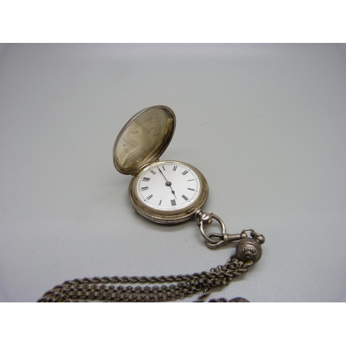 1047 - A silver full hunter fob watch on a white metal Albertina chain