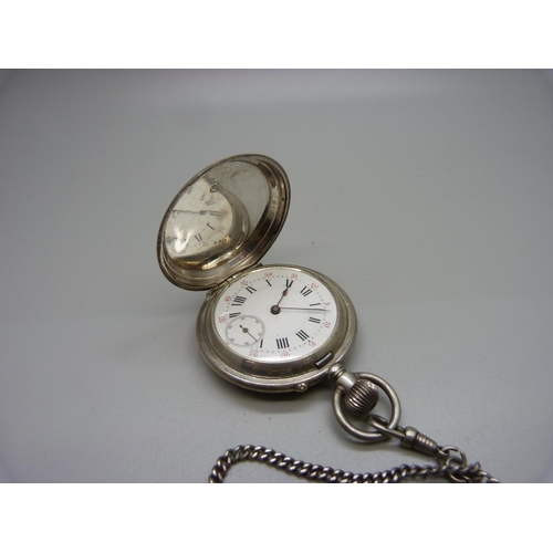 1048 - A white metal full hunter pocket watch, with inscription dated 1889, (tests as silver), on a chain