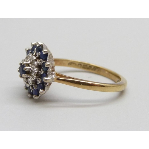 1061 - An 18ct gold, sapphire and diamond cluster ring, 4.34g, M