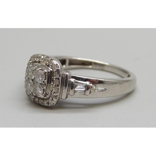 1064 - A 9ct white gold and diamond halo ring, 2.8g, K