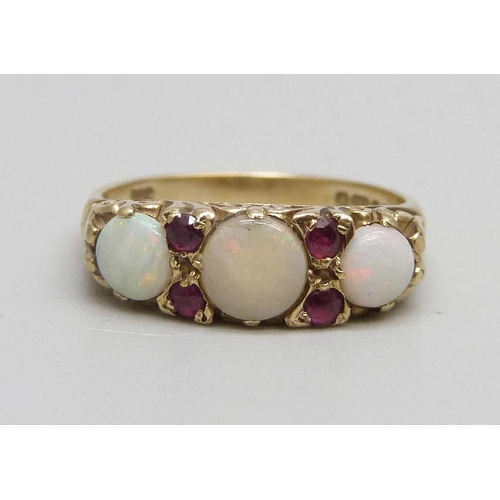 1066 - A 9ct gold, opal and ruby set ring, 3.5g, O, centre stone cracked