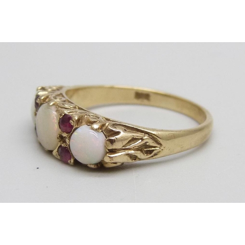 1066 - A 9ct gold, opal and ruby set ring, 3.5g, O, centre stone cracked