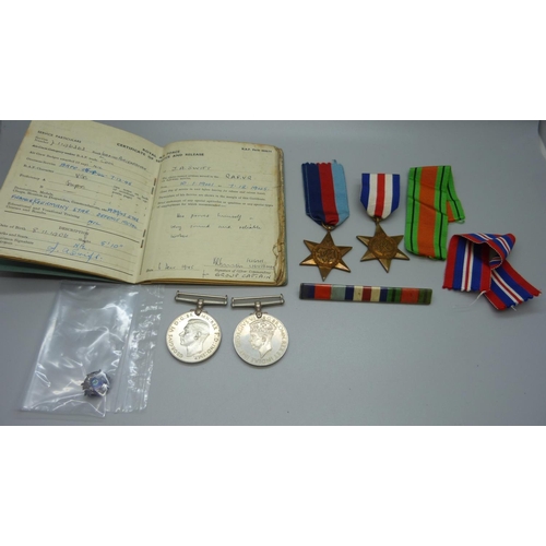 1073 - A Royal Air Force Service and Release Book, a silver and enamel Royal Canadian Air Force badge and f... 