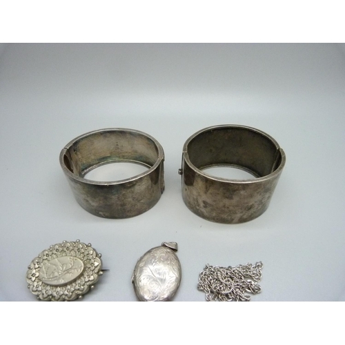 1084 - Two silver bangles, two silver lockets and a brooch lacking hook