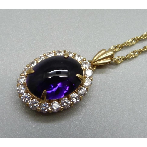 1093 - A 14ct gold mounted purple cabochon and paste pendant on a 14ct gold chain, 10.8g