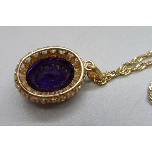 1093 - A 14ct gold mounted purple cabochon and paste pendant on a 14ct gold chain, 10.8g