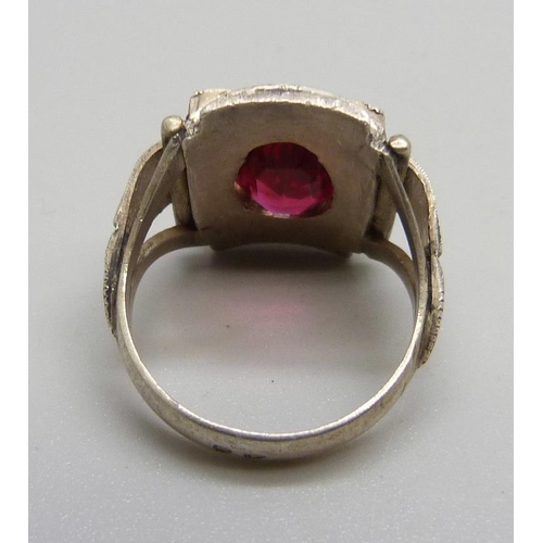 1106 - An Eastern European Art Deco silver ring with applied gold and set with a red stone, J