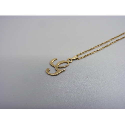 1107 - A yellow metal pendant on a fine 9ct gold chain, 2.1g