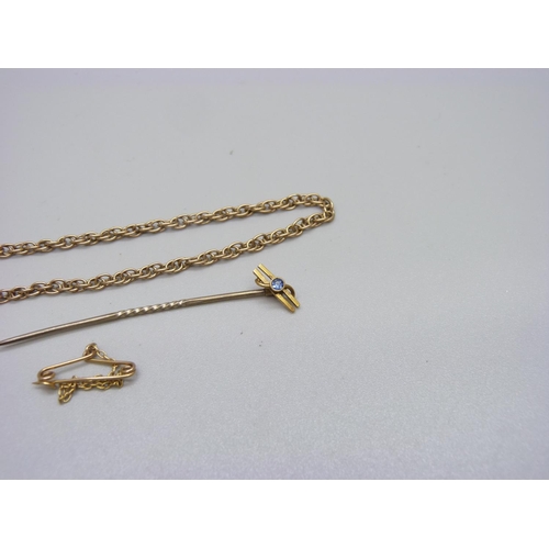 1144 - A 15ct gold stick pin, a 9ct gold cross pendant and a 9ct gold rope chain, a/f, 4.7g without stick p... 