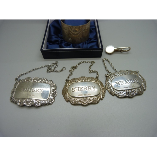 1151 - Three silver wine labels, a silver clip and a silver napkin ring, 71g