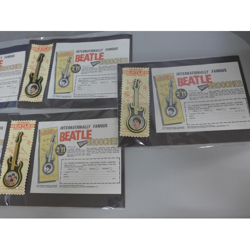 617 - The Beatles guitar brooches with later adverts order forms