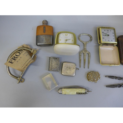 661 - Assorted items including a hip flask, vesta cases, travel clocks, etc.