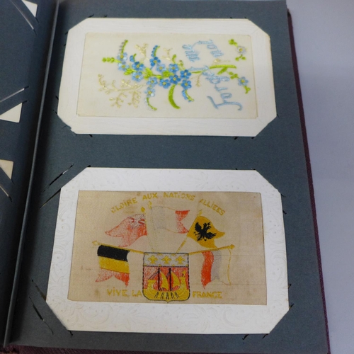 673 - Postcards; two albums of military related postcards, one of silks (26 no.) and one of general items ... 