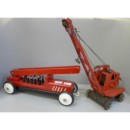 684 - A Tri-ang crane and a wooden fire engine toy with figures