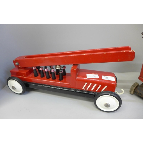 684 - A Tri-ang crane and a wooden fire engine toy with figures