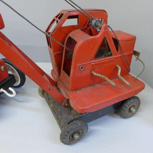 684 - A Tri-ang crane and a wooden fire engine toy with figures