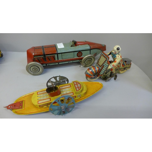 690 - A collection of tin-plate model vehicles including a motorbike, a boat etc.