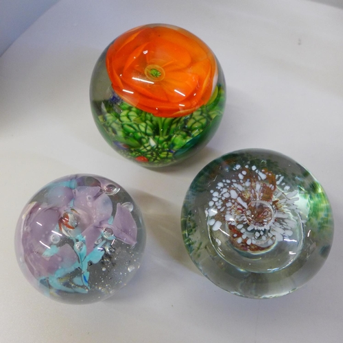 705 - A collection of glassware comprising three paperweights and a centrepiece on stand