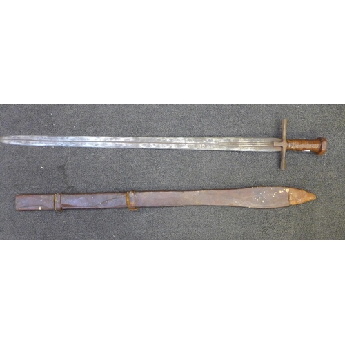 832 - A late 19th Century Sudanese Kaskara sword with leather scabbard