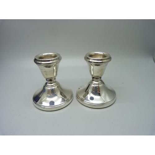 870 - A pair of small silver candlesticks in fitted case