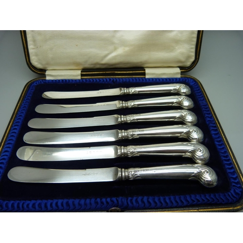 876 - A cased set of six silver handled pistol grip knives, Sheffield 1898