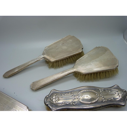 888 - Four silver backed brushes and one silver mounted