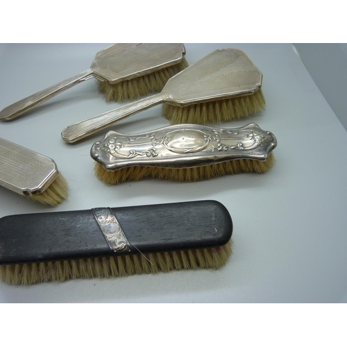 888 - Four silver backed brushes and one silver mounted