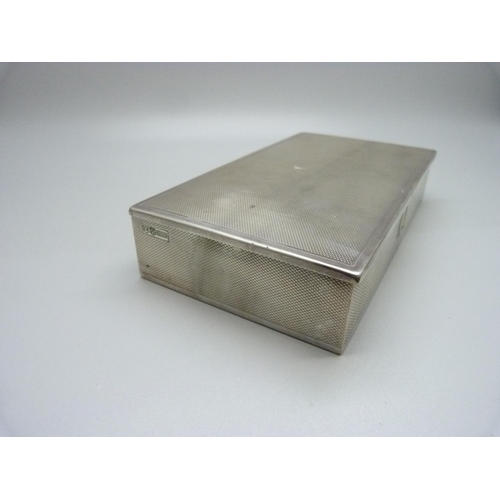 897 - A silver cigarette case with Omega mark, also marked Made in Switzerland, total weight 262gms, 15.5c... 