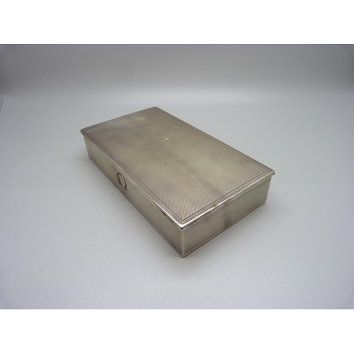 897 - A silver cigarette case with Omega mark, also marked Made in Switzerland, total weight 262gms, 15.5c... 