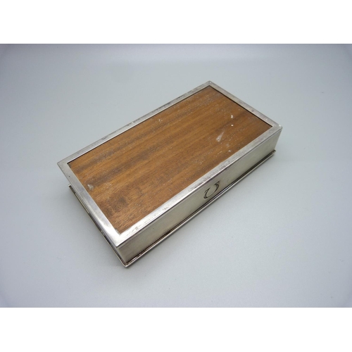 897 - A silver cigarette case with Omega mark, also marked Made in Switzerland, total weight 262gms, 15.5c... 