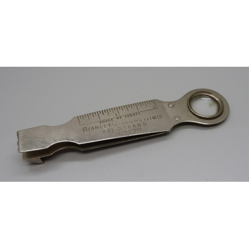 915 - A stamp measure with magnifying glass, marked Stanley Gibbons