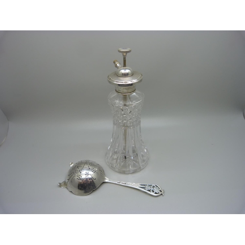 919 - A silver topped scent spray and a silver tea strainer, (strainer 46g)