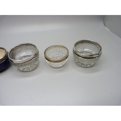 930 - A pair of silver mounted cut glass salts and four other silver rimmed salts