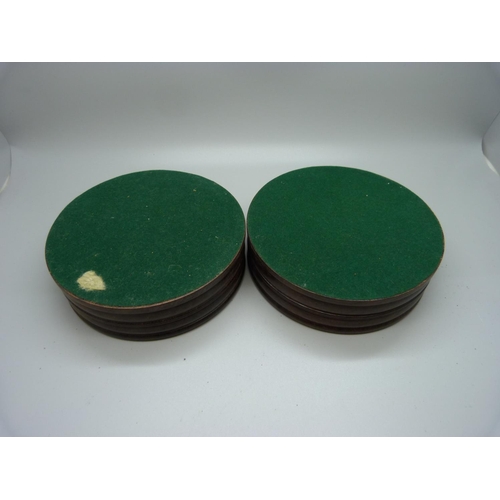 945 - A pair of turned wood wine coasters with inset silver