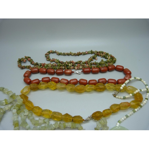 946 - A collection of gemstone jewellery including jadeite pendants and other hard stones