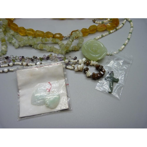 946 - A collection of gemstone jewellery including jadeite pendants and other hard stones