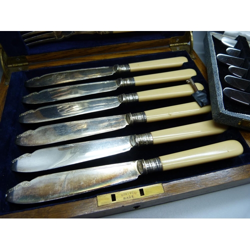 954 - A set of silver handled knives, 1935, and a set of knives and forks with silver ferrules in a wooden... 