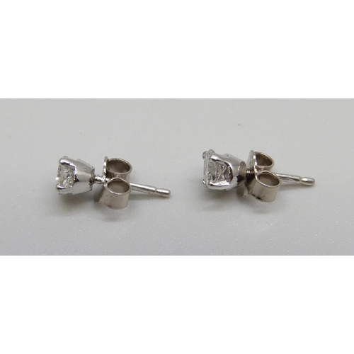 978 - A pair of 18ct white gold and diamond stud earrings, total diamond weight, 0.70 carats