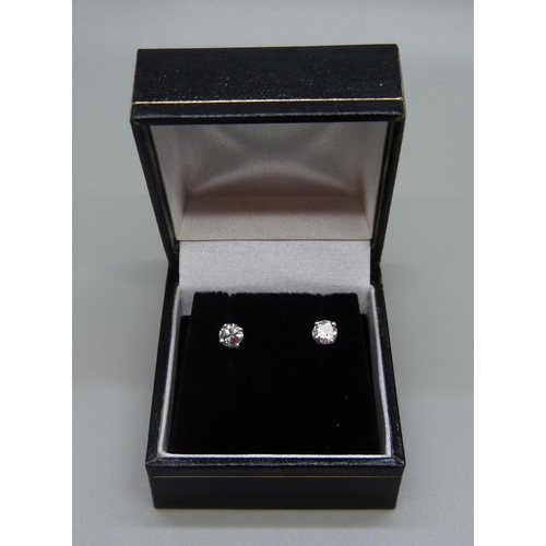 978 - A pair of 18ct white gold and diamond stud earrings, total diamond weight, 0.70 carats